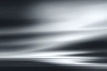 Abstract grayscale image of smooth, flowing lines and light streaks, creating a sense of motion and depth