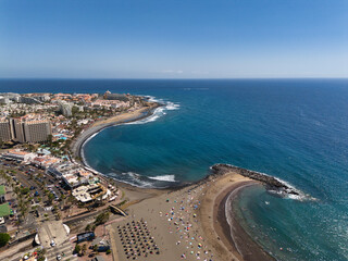 Fototapeta premium Beautiful aerial photo of the coast of Tenerife, the city, the sandy beach and the Atlantic Ocean