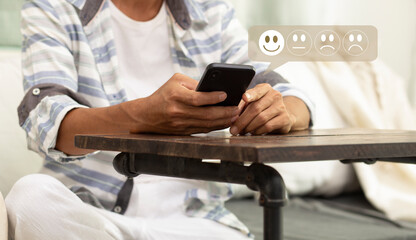Customer pressing on smartphone with smile icon for feedback review satisfaction service	
