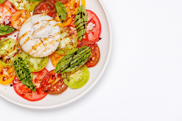 Fresh burrata served on slices of colorful tomatoes