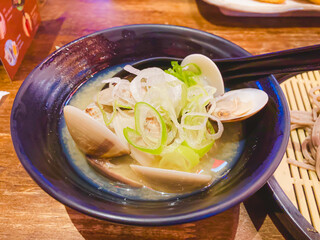 A variety of delicious Clams soups served in bowls with vegetables and meat