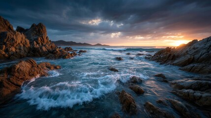Obraz premium Vibrant Sunset Over Rocky Ocean Coast