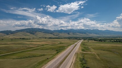 Scenic Highway View Through Montana Landscape with Blue Sky and Rolling Hills on a Sunny Day