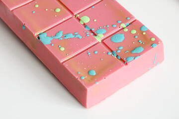 Ruby chocolate bar decorated with a colorful pattern of splashes resembling a galaxy
