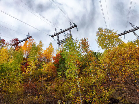 Krasnoyarsk Hydroelectric Power Station surrounded by autumn foliage and power lines in Siberia