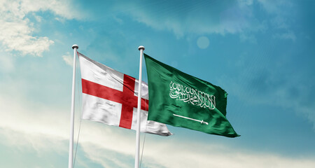 England and Saudi Arabia friendship flags are waving in the sky. Two country flag for agreement or deal. England KSA national flag for commitment.