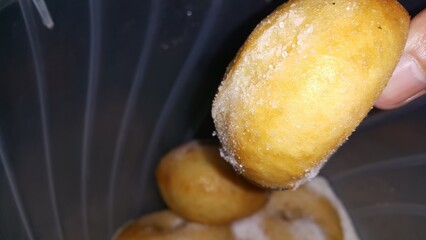 Selective focus shot of delicious and indulgent sweet sugar donut. Donut, Donut or Doughnut, popular cake made from flour and potatoes with icing sugar on top.