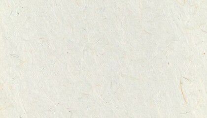 Fototapeta premium A close-up view of off-white textured paper reveals small fibers and slight variations in tone.