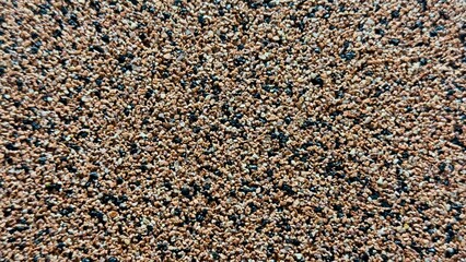 Granular Surface of Brown, Black, and White Pebbles — Natural Texture for Design, Construction, and Educational Use