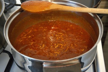 Freshly cooked homemade Bolognese sauce in a stainless steel pot. Rich and hearty meat sauce.