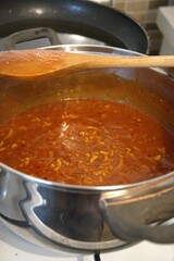 Freshly cooked homemade Bolognese sauce in a stainless steel pot. Rich and hearty meat sauce.
