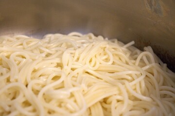 Close-up of freshly boiled spaghetti pasta in a cooking pot. Homemade meal preparation concept.