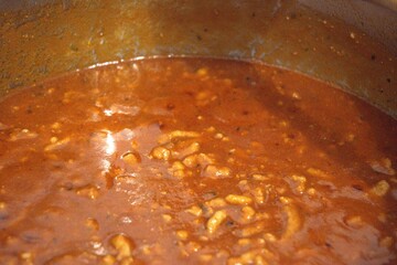 Freshly cooked homemade Bolognese sauce in a stainless steel pot. Rich and hearty meat sauce.