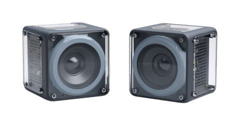 Two cube-shaped, gray audio devices with visible speaker cones