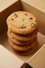 Delicious homemade chocolate chip cookies stacked in a box ready to be eaten fresh baked