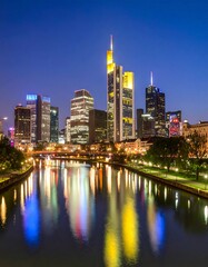 Obraz premium City skyline at night, reflecting in a river