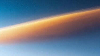 Stunning orange cloud streak across vivid blue sky at dawn or dusk