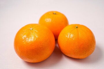 Orange, fresh tangerines on white table background	