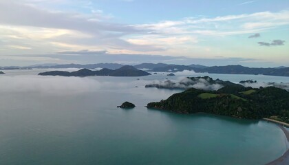 Misty islands in a tranquil bay.