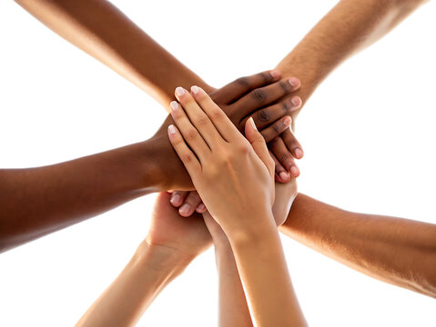Diverse group of hands stacked together against a bright white background showing unity and teamwork