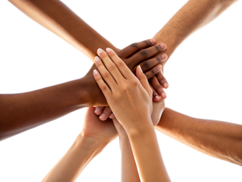 Diverse group of hands stacked together against a bright white background showing unity and teamwork