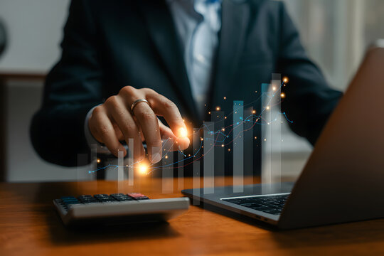Businessman analyzing financial data with digital graph and laptop