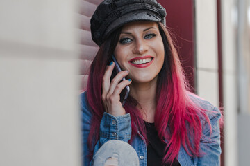 urban woman on the street talking on her mobile phone