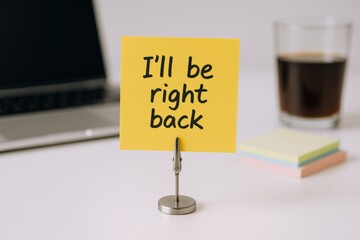 Office Break Reminder: Sticky Note with 'I'll be Right Back' Message on Desk
