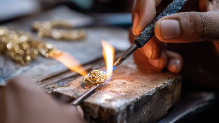 Fototapeta premium Jewelry maker soldering tiny gold detail