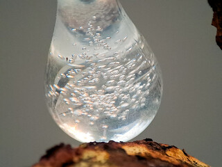 Transparent Teardrop Resin with Air Bubbles on Rustic Wood