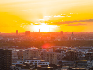 Aerial view of Copenhagen, Denmark, at sunset featuring modern and historic architecture, tall...