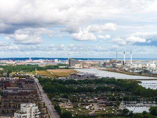 Aerial view of Copenhagen, Denmark, featuring Amager Bakke, a waterway, green spaces, modern...