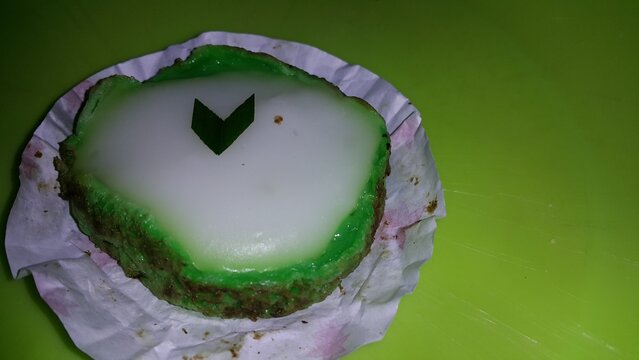 Green and white Lapindo Mud Cake (talam) garnished with green pandan leaves looks beautiful and enchanting. delicious and special.