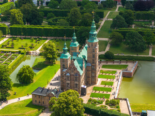 Aerial view of Rosenborg Castle in Copenhagen, Denmark, featuring green spires, Renaissance...