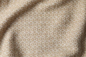 Beige warm blanket with waves, top view