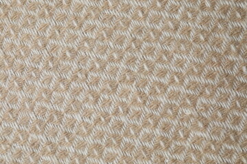 Texture of beige warm blanket with waves, top view