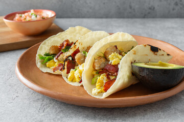 A view of some breakfast tacos, featuring gluten-free flour style tortillas.