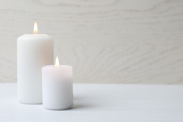 White candles on wooden table