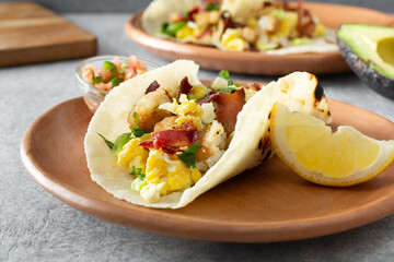 A view of a breakfast taco, featuring a gluten-free flour style tortilla.