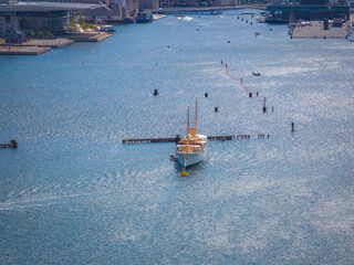 Aerial view of a waterway in Copenhagen, Denmark, featuring Queens yacht, buoys, a red barrier,...
