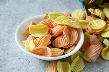 A view of a pile of ridged vegetable chips in a bowl.