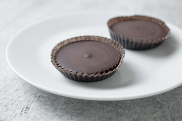 A view of some peanut butter cups, on a plate.