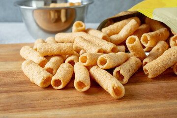 A closeup view of a pile of cauliflower puffs, spilling out of the package.