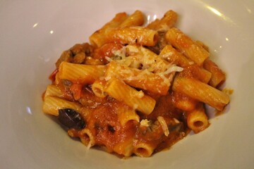Italian cuisine: rigatoni with beef strips and tomato sauce in Venice, Italy