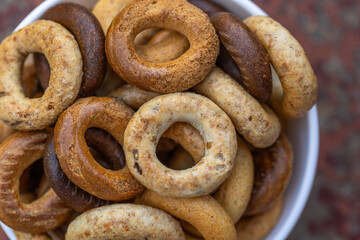 Freshly baked mini bagels on a dark background. Top view. Pretzels in the form of a ring close-up....