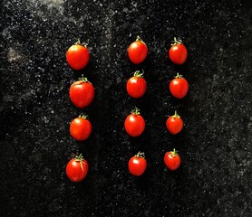 red tomatoes on a black marble table