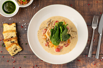 Tender chicken breast in creamy sauce with cherry tomatoes and spinach
