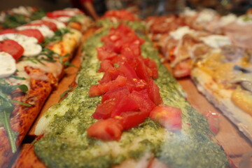 Varieties of Italian pizzas displayed in a vitrine in Venice, Italy