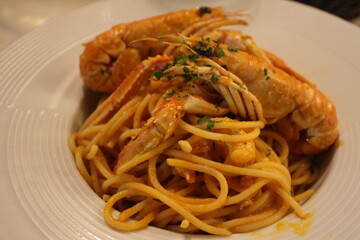 Italian cuisine: spaghetti alla busara (spaghetti with scampi and tomato sauce) in Venice, Italy