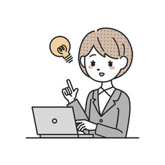 パソコンの前でひらめくスーツを着た女性